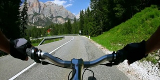 HD骑着自行车沿着一条高山路下山