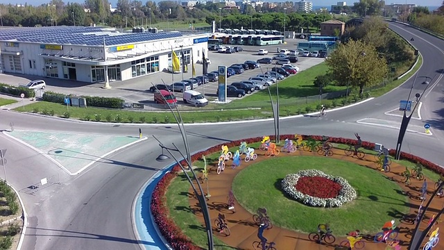 Sustainability-industrial_building_w_solar_panel_near_bike_roundabout