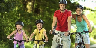 父母和他们的两个孩子骑自行车