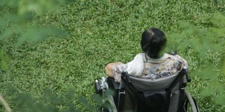 坐在轮椅上的亚裔老年妇女