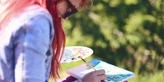 年轻女子在户外画风景画