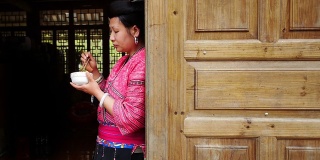 穿着传统服装吃米饭的中国妇女