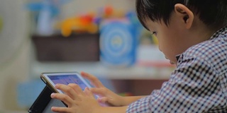 小男孩使用数码平板电脑。