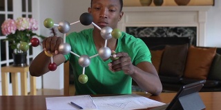 青少年通过研究分子模型来学习科学