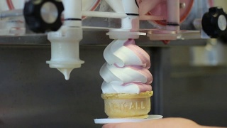 从机器上制作扭曲的粉色和白色冰淇淋蛋卷视频素材模板下载