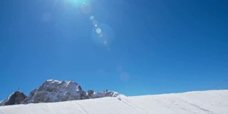 SLO MO滑雪板跳过蓝色清澈的天空