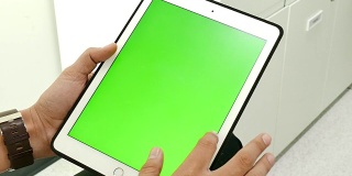 近距离男子持有空白平板电脑与绿色