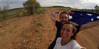 一对年轻夫妇与袋鼠标志自拍，澳大利亚