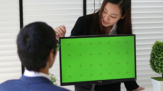 4K:两个亚洲人在电脑绿屏上谈生意