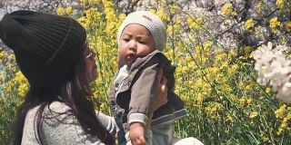 Asian mother and baby enjoying the spring
