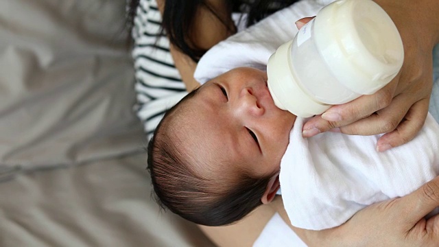 Mother used bottle feeding baby newborn