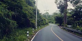 泰国乡村公路上行驶的汽车前面的慢镜头
