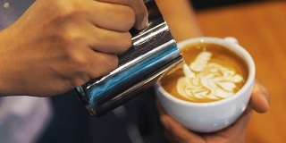 咖啡拿铁艺术，咖啡师倒牛奶。