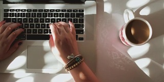 俯视图女性的手使用笔记本电脑