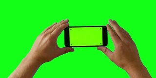 手持智能手机在绿色屏幕BG - 4K