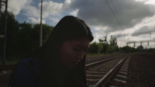 一个可悲的亚洲女人坐在火车上。视频素材模板下载