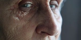 一位年长女性的眼睛转向了镜头，但她的目光却移开了