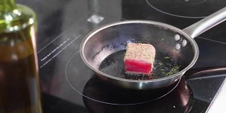 煎鱼，马林鱼片放在热气腾腾的煎锅上。