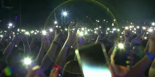 背景-观众与手电筒的智能手机在摇滚音乐会