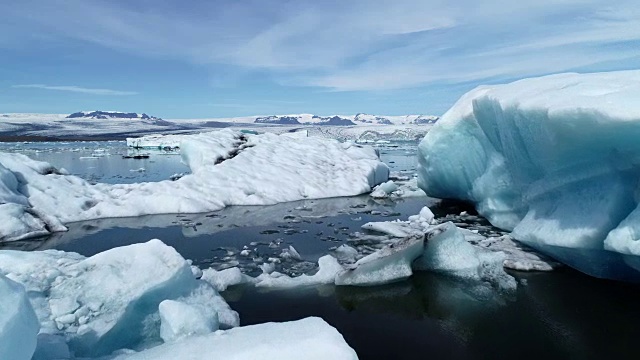 低空飞行鸟瞰图美丽的Jokulsarlon蓝色冰川泻湖与巨大的冰山在冰岛