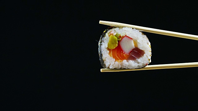 寿司质量高，打开黑色背景，显示其所有的好，饮食和健康的食物，美味的味道，寿司很好与鲑鱼或金枪鱼，是一个典型的日本食物