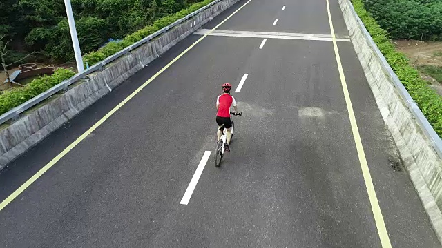 鸟瞰图的女子骑自行车下匝道高速公路