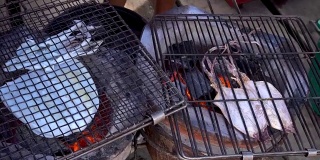 美味的烤鱿鱼和干鱿鱼在泰国的街头小吃摊上，在海边的路上卖