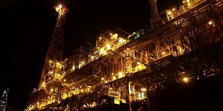 夜间靠近石油平台平台的FPSO油轮。海上石油和天然气工业