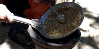 特写的一个小贩准备kerak telor，一种辣的煎蛋卷，在库塔海滩