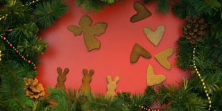 姜饼饼干在装饰云杉树枝上跳舞的背景，圣诞