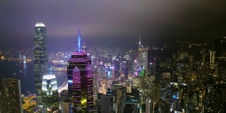 无人机在香港中环夜间拍摄的鸟瞰图。现代化的摩天大楼和大都市的高楼大厦，城市交通系统。