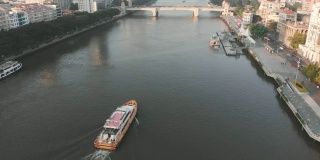 在广州的日出。无人机在珠江上空飞行。在河上漂浮的小船