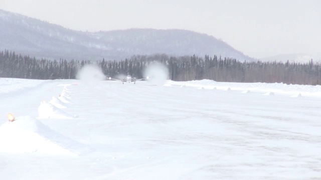 一架小型私人飞机降落在偏僻的雪地跑道上