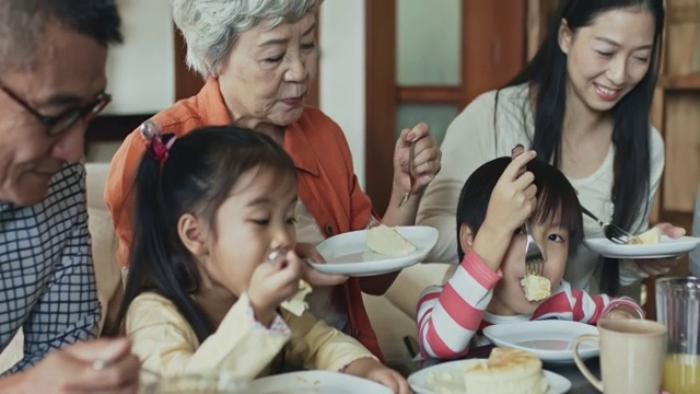 几代同堂的中国家庭在享受生日蛋糕