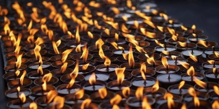 尼泊尔一座佛教寺庙旁点燃多支仪式蜡烛。慢动作特写镜头