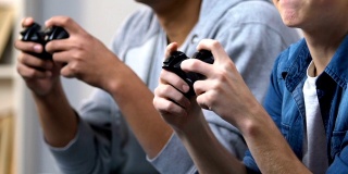两个男性青少年玩电子游戏，紧张失去朋友，空闲时间