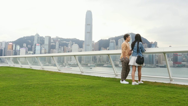 快乐的亚洲夫妇欣赏香港的天际线