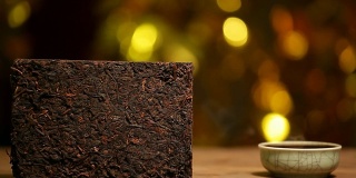 黑色的中国热茶杯，木桌，金色的散景，高清的画面，没人