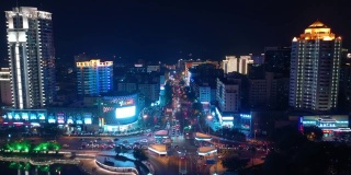 夜晚照亮三亚市交通街道十字路口江边航拍全景4k中国海南