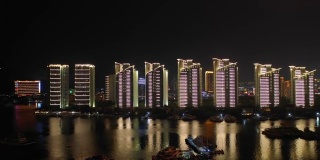 夜晚照亮三亚滨江湾码头公寓综合体航拍4k中国海南