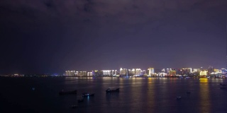 夜晚照亮三亚市湾屋顶全景4k时间推移海南岛中国