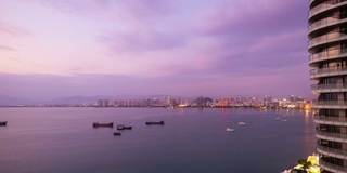 从早到晚著名的三亚湾酒店综合楼侧全景4k时间跨度海南岛中国