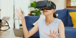 近距离的年轻亚洲女性使用虚拟现实眼镜与幸福而坐在家里客厅的运动垫，人们在幸福的时刻，Z一代的生活方式