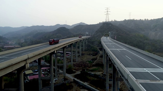 高速公路翻山越岭，汽车和卡车双向行驶
