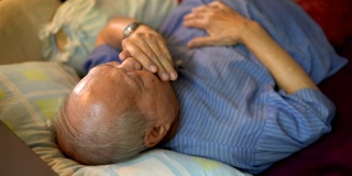 Illness Senior Asian man Coughing on bed