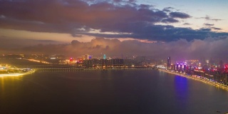 日落时间照明飞行在澳门城市湾空中全景4k时间间隔中国