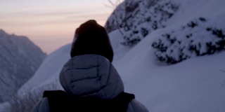 冬天的山探险。小径上的年轻夫妇。日落