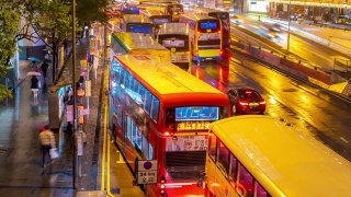 时光倒流:香港市中心的公交车站排队等候，夕阳下着雨视频素材模板下载