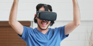 年轻的亚洲男人用虚拟现实眼镜与幸福在卧室，近距离，人们在幸福的时刻，生活方式，人和技术