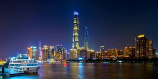 时间流逝的上海市区与黄浦江，中国。亚洲智慧城市的金融区和商业中心。晚上有摩天大楼和高层建筑。